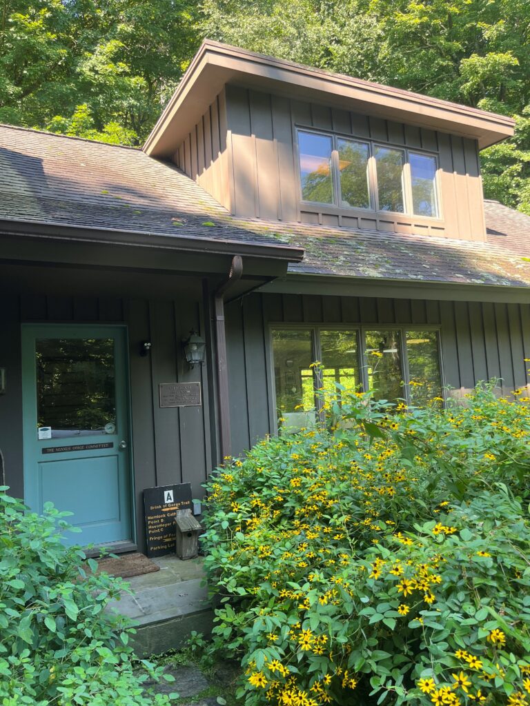 Exterior of the old Mianus River Gorge Office, a brown building with a teal door